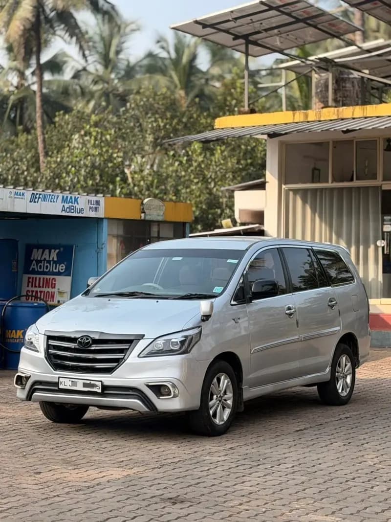 Used 2013 Toyota Innova G4 diesel in silver, front three-quarter view, for sale at RR Motors, Iritty, Kannur