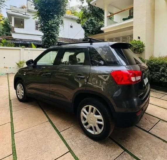 2018 Maruti Suzuki Vitara Brezza VDi diesel in grey, rear three-quarter view from the left – Car City, Mattanur, Kannur