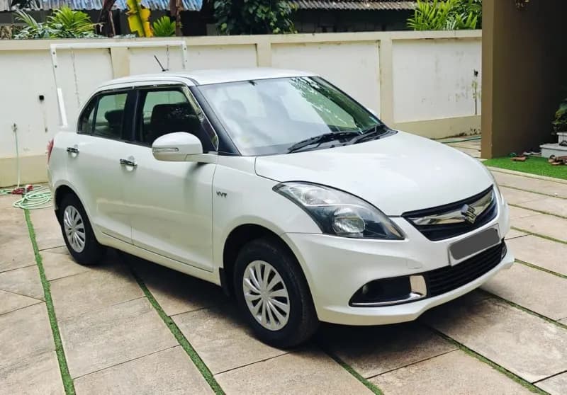Used 2016 Maruti Suzuki Swift Dzire VXi petrol in white, front three-quarter view, for sale at Car City, Mattanur, Kannur