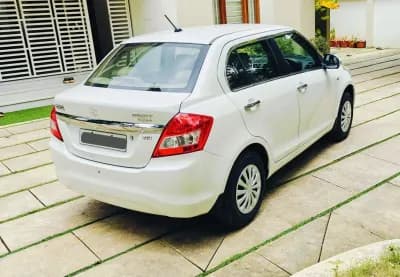 2016 Maruti Suzuki Swift Dzire VXi petrol in white, rear three-quarter view – Car City, Mattanur, Kannur