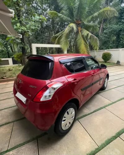 2012 Maruti Suzuki Swift VDi diesel in red, rear three-quarter view with VDi badge – Car City, Mattanur, Kannur