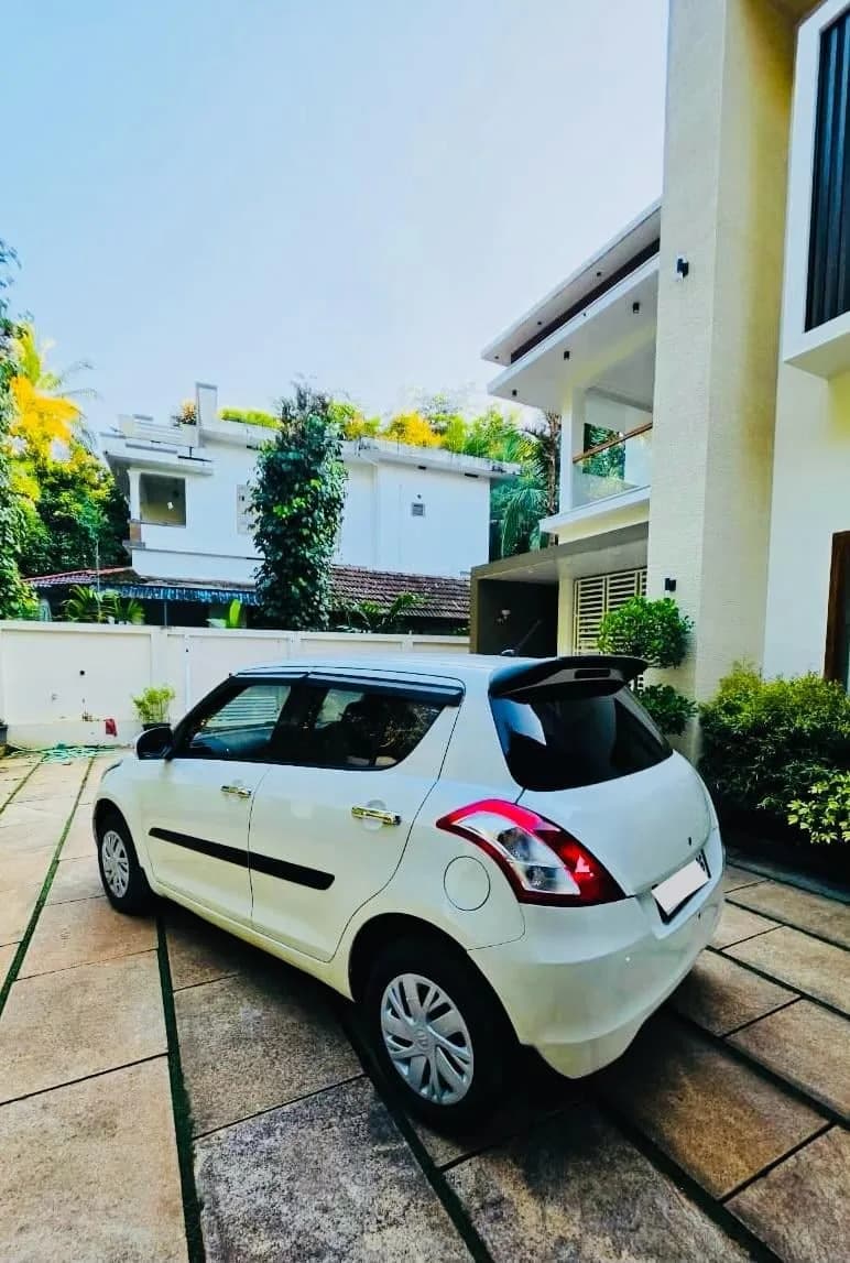 2017 Maruti Suzuki Swift VDi diesel in white, rear three-quarter view from the left – Car City, Mattanur, Kannur